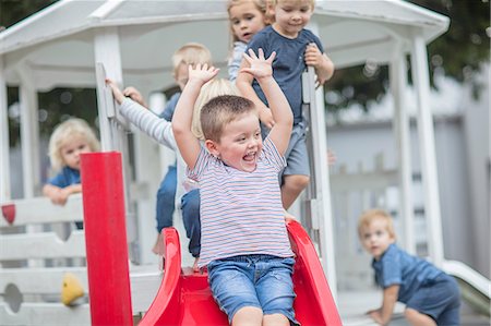 simsearch:649-07804176,k - Boys and girls at preschool, sliding on playground slide in garden Stock Photo - Premium Royalty-Free, Code: 614-09057264