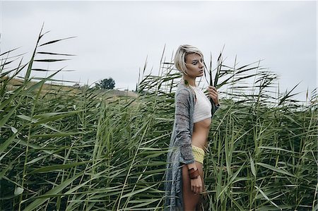 stomach (lower abdomen) - Side view of woman in tall grass looking away, Odessa, Odeska Oblast, Ukraine, Europe Stock Photo - Premium Royalty-Free, Code: 614-09057494