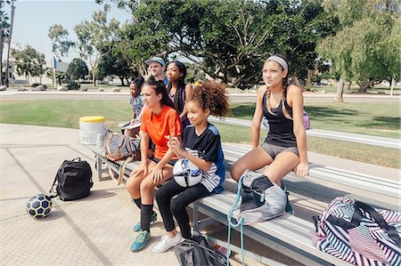 schoolgirl - Male teacher and schoolgirls watching soccer practice on school sports field Stock Photo - Premium Royalty-Free, Code: 614-09078933