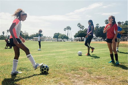simsearch:614-08270379,k - Schoolgirls practicing face to face with soccer ball on school sports field Stock Photo - Premium Royalty-Free, Code: 614-09078959