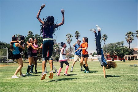 Schoolgirl soccer team jumping for joy on school sports field Stock Photo - Premium Royalty-Free, Code: 614-09078964