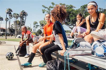simsearch:614-07768068,k - Schoolgirl soccer players chatting on school sports field bench Stock Photo - Premium Royalty-Free, Code: 614-09079017