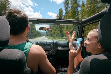 people feet up - Young woman with instant camera driving on road trip with boyfriend, Breckenridge, Colorado, USA Stock Photo - Premium Royalty-Free, Code: 614-09110914