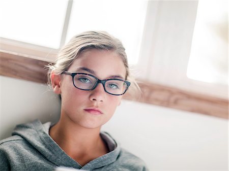 Girl in spectacles, portrait at home Stock Photo - Premium Royalty-Free, Code: 614-09127474