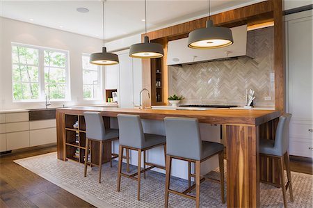 Walnut wood kitchen island in a luxurious contemporary home Stock Photo - Premium Royalty-Free, Code: 614-09159582