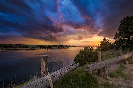 Fading supercell over lake at sunset, Ogallala, Nebraska, US Stock Photo - Premium Royalty-Free, Code: 614-09168142