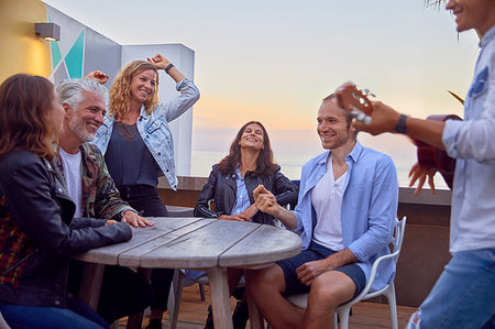 Friends at party by beach, Plettenberg Bay, Western Cape, South Africa Stock Photo - Premium Royalty-Free, Code: 614-09178392