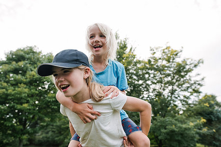 sister with brother - Children playing piggyback in park Stock Photo - Premium Royalty-Free, Code: 614-09178518