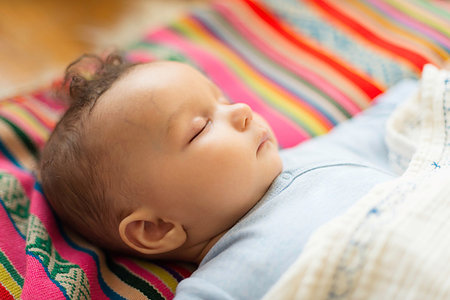 simsearch:614-07031850,k - Baby boy asleep on colourful textile Stock Photo - Premium Royalty-Free, Code: 614-09183051