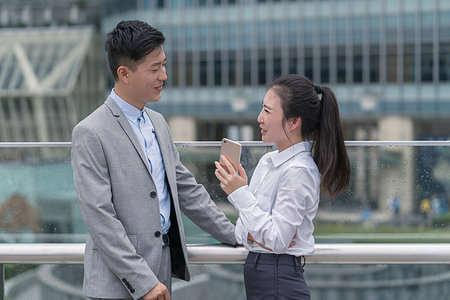 Young businesswoman and man talking in city, Shanghai, China Stock Photo - Premium Royalty-Free, Code: 614-09183097