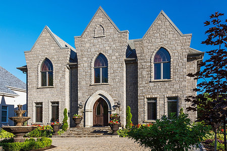 Gothic style house in grey stone with arched windows, facade Stock Photo - Premium Royalty-Free, Code: 614-09183209