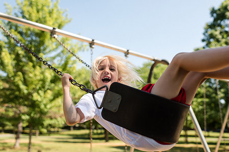 simsearch:649-07647801,k - Boy on swing in park Stock Photo - Premium Royalty-Free, Code: 614-09198287