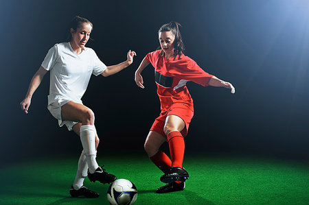 simsearch:614-07239995,k - Two female soccer players tackling ball Stock Photo - Premium Royalty-Free, Code: 614-09210341