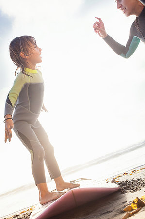simsearch:649-07437620,k - Mother and daughter practicing surfing on beach, Encinitas, California, USA Stock Photo - Premium Royalty-Free, Code: 614-09210689