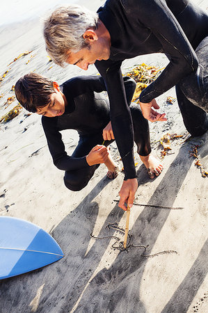 simsearch:649-07596731,k - Father and son surfers at beach, Encinitas, California, USA Stock Photo - Premium Royalty-Free, Code: 614-09210696
