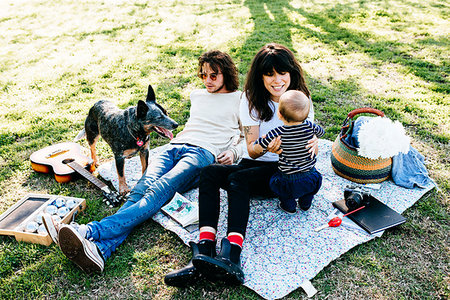 Couple with baby on picnic blanket in park Stock Photo - Premium Royalty-Free, Code: 614-09211369