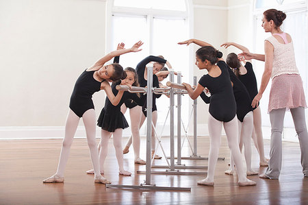 simsearch:614-08270379,k - Ballet teacher teaching group of girls ballet position at the barre Stock Photo - Premium Royalty-Free, Code: 614-09211465