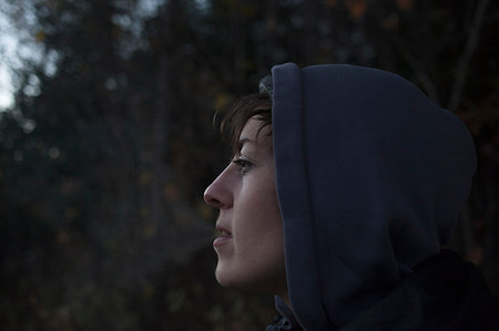 simsearch:614-08392638,k - Close up portrait of mid adult woman gazing from forest at dusk Stock Photo - Premium Royalty-Free, Code: 614-09211693