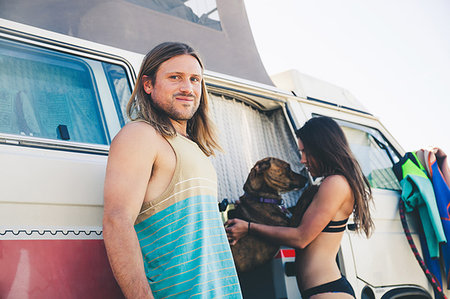 san clemente - Couple standing beside camper van, pet dog jumping up at woman Stock Photo - Premium Royalty-Free, Code: 614-09211813