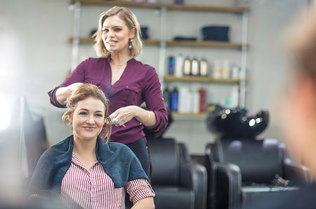 simsearch:6118-08660009,k - Hairdresser styling customer's hair in salon Stock Photo - Premium Royalty-Free, Code: 614-09213774