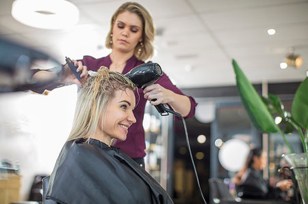 simsearch:6118-08660009,k - Hairdresser blow drying customer's hair in salon Stock Photo - Premium Royalty-Free, Code: 614-09213770