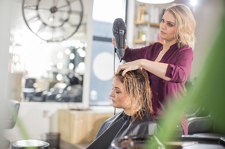 simsearch:6118-08660009,k - Hairdresser blow drying customer's hair in salon Stock Photo - Premium Royalty-Free, Code: 614-09213781