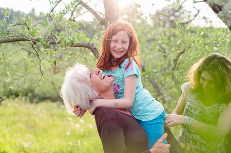 simsearch:6122-07698008,k - Girl getting carried by grandmother, with mother in garden Stock Photo - Premium Royalty-Free, Code: 614-09245259