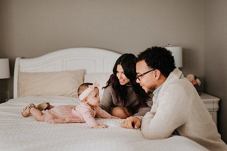 simsearch:700-01582158,k - Couple with baby daughter on bed in bedroom Stock Photo - Premium Royalty-Free, Code: 614-09249526