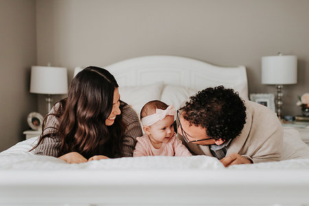 simsearch:700-01582158,k - Couple with baby daughter on bed in bedroom Stock Photo - Premium Royalty-Free, Code: 614-09249528