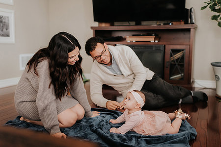 simsearch:700-01582158,k - Couple playing with baby daughter in living room Stock Photo - Premium Royalty-Free, Code: 614-09249537