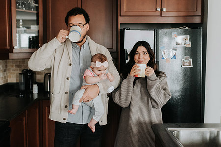 simsearch:700-01582158,k - Couple having drink and carrying baby daughter in kitchen Stock Photo - Premium Royalty-Free, Code: 614-09249554