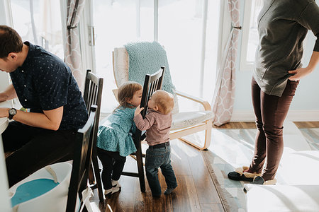 simsearch:649-07437107,k - Baby boy and toddler sister playing in living room with mother and father Stock Photo - Premium Royalty-Free, Code: 614-09249647
