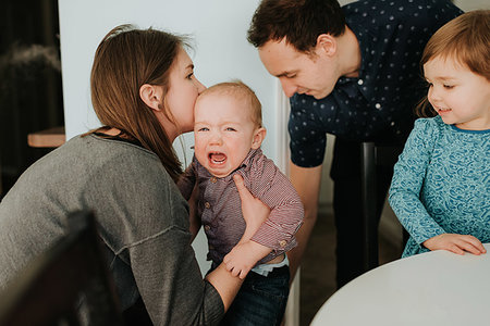 simsearch:649-07437107,k - Mid adult couple with toddler daughter and crying baby son in living room Stock Photo - Premium Royalty-Free, Code: 614-09249658