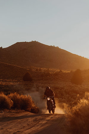 Motorbiker riding through landscape of Kennedy Meadows, California, US Stock Photo - Premium Royalty-Free, Code: 614-09259157