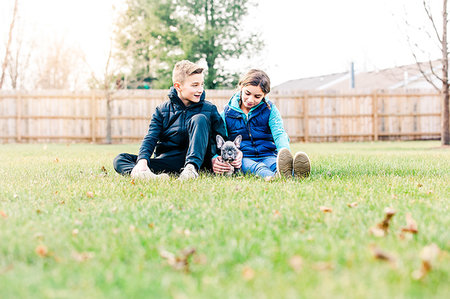 simsearch:649-08004031,k - Children playing with puppy on grass Stock Photo - Premium Royalty-Free, Code: 614-09253602