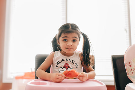 simsearch:614-07806265,k - Girl in high chair holding water melon, portrait Stock Photo - Premium Royalty-Free, Code: 614-09253672