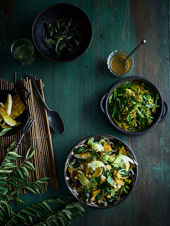 simsearch:614-01088098,k - Rustic low key still life with bowls of curry leaf fish salad and green bean thoran on table, overhead view Stock Photo - Premium Royalty-Free, Code: 614-09276361