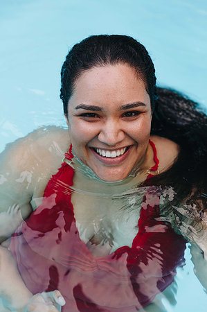 Mid adult woman with wet hair in outdoor swimming pool, portrait, Cape Town, South Africa Stock Photo - Premium Royalty-Free, Code: 614-09276658