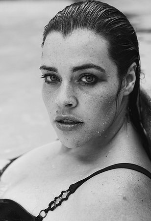 fat woman in bathing suit - Sultry mid adult woman with wet hair leaning against outdoor swimming poolside, black and white head and shoulder portrait, Cape Town, South Africa Stock Photo - Premium Royalty-Free, Code: 614-09276676