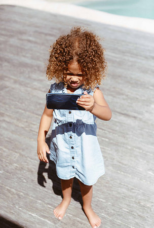 simsearch:614-06043612,k - Little girl using smartphone on porch Stock Photo - Premium Royalty-Free, Code: 614-09276836