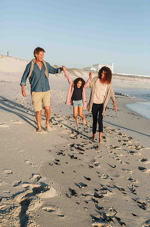 simsearch:614-08030822,k - Couple swinging daughter in mid air on sandy beach Stock Photo - Premium Royalty-Free, Code: 614-09276956