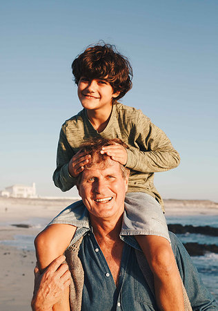 simsearch:649-07596731,k - Father giving son piggyback ride on beach Stock Photo - Premium Royalty-Free, Code: 614-09276964