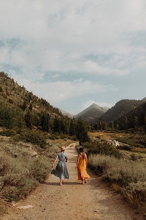 simsearch:614-09078761,k - Two woman in maxi dresses strolling on rural valley road, rear view, Mineral King, California, USA Stock Photo - Premium Royalty-Free, Code: 614-09270436