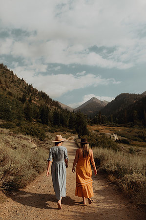 simsearch:614-09078761,k - Two woman in maxi dresses strolling on rural valley road, rear view, Mineral King, California, USA Stock Photo - Premium Royalty-Free, Code: 614-09270437