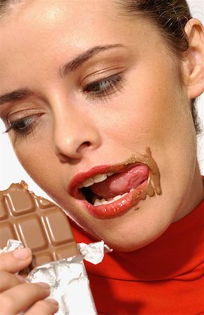 Young woman eating chocolate Stock Photo - Premium Royalty-Free, Code: 614-00382418