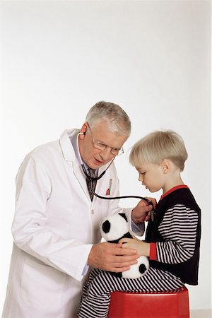 simsearch:614-00599645,k - Doctor listening to boy's chest Stock Photo - Premium Royalty-Free, Code: 614-00597414