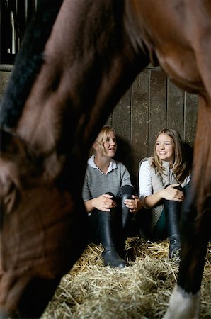 riding boots not equestrian not cowboy not child - A horse in front of two women in a stable Stock Photo - Premium Royalty-Free, Code: 614-00602824