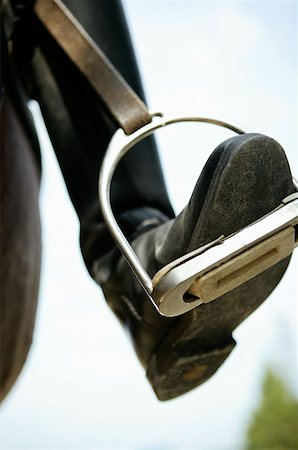 riding boots not equestrian not cowboy not child - A foot in a stirrup Stock Photo - Premium Royalty-Free, Code: 614-00602858