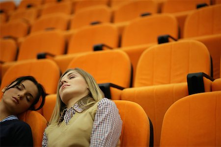 Two young women asleep in a lecture theatre Stock Photo - Premium Royalty-Free, Code: 614-00655632