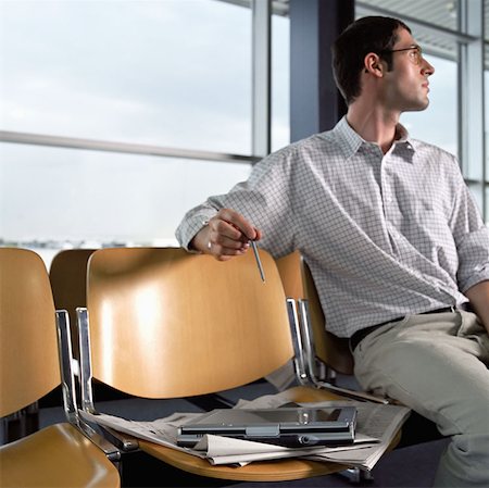 Man in departure lounge Stock Photo - Premium Royalty-Free, Code: 614-00655726